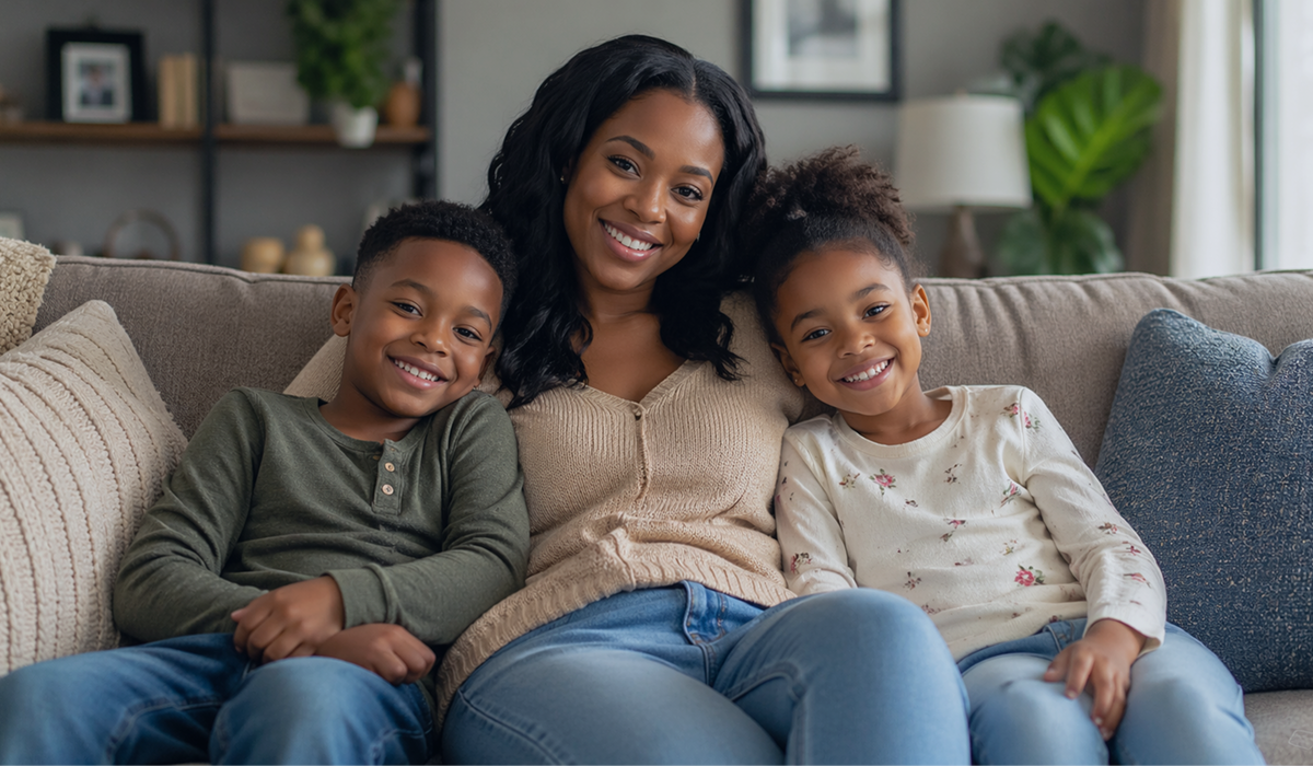 Mother hugging two children on a couch